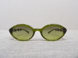 green sunglasses on a white tablecloth with a white background