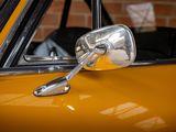 a close up of a side view mirror on a yellow car