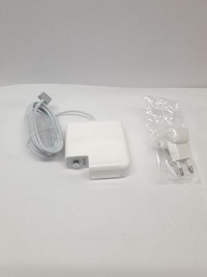 an apple power adapter and charger sitting on top of a white table