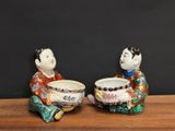 two figurines that are sitting on a table