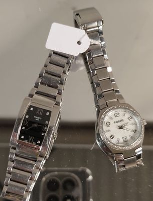 une montre posée sur une table à côté d'un téléphone portable