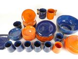 many different colored dishes and cups on the table