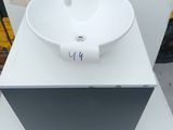 a white sink sitting on top of a white counter