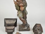 a statue of a man holding a lamp and other items