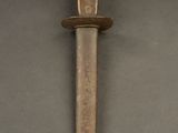 a picture of a knife that is on a table