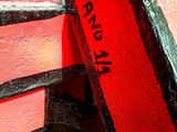 a close up of a red and black cake with a name on it