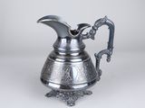 a silver pitcher with a handle and a handle on a white background