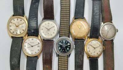 several different types of watches are displayed on a white surface