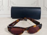 a pair of sunglasses sitting on top of a table next to a case