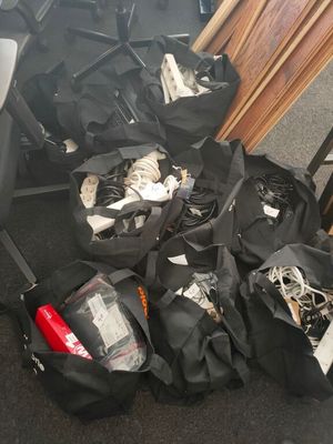 many bags of luggage sitting on the floor next to a chair