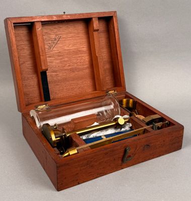 a wooden box with a glass bottle inside of it