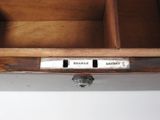 a close up of a wooden drawer with a metal handle