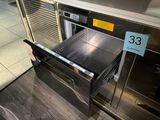 a stainless steel oven with a drawer in the middle