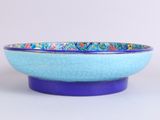 blue and purple bowl with a floral design on the rim