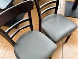 two black chairs sitting next to each other on a tiled floor