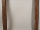 an old wooden picture frame with a white wall in the background