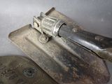a gun that is on top of a piece of metal