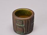 a close up of a small cup with a design on it