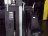 a gym room with a cross training machine and other equipment