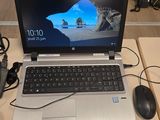 a laptop computer sitting on top of a desk with a mouse