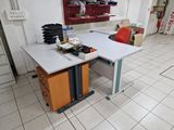 a white table with a red chair in the middle of the room