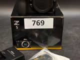 a box with a camera and some other items on the table