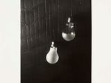 black and white photograph of two light bulbs hanging from a wall
