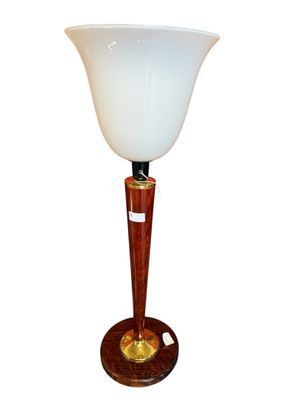 a lamp that has a wooden base and a glass shade on it