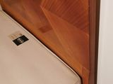a bed with a wooden headboard and a mattress on it