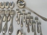 a lot of silver spoons and spoons on the table