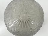 a clear glass bowl with a circular design on it