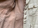 an image of a pair of military jackets hanging on a wall