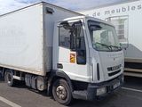 un camion blanc garé dans un parking