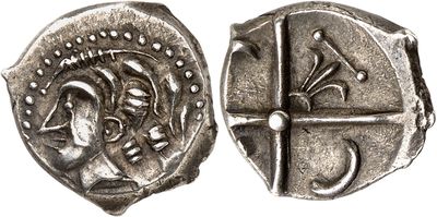 a close up of a silver coin with a face on it