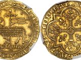 a close up of two gold coins on a white surface