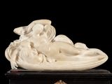 a statue of a woman laying down on a box