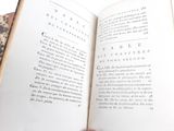a person holding an open book in their hand