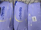 three bags of diapers are stacked on top of each other in a shopping cart