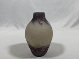 a brown and white vase sitting on a white surface