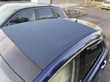 a blue car parked in a parking lot next to a parking meter