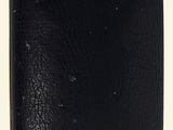 black leather wallet on a white background with a small hole in the middle