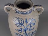 a blue and white vase sitting on a table