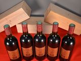 six bottles of wine are lined up on a red cloth