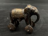 a small elephant that is sitting on a table