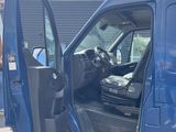 a blue van with its door open in a parking lot