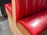 a bench made out of wood and red leather