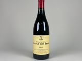 a bottle of red wine sitting on top of a table