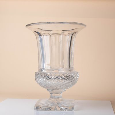 a glass vase sitting on top of a white table