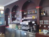 a bar with a lot of bottles on the shelves
