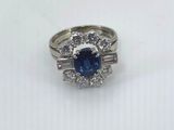 a blue sapphire and diamond ring on a white background